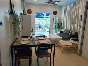 a kitchen and living room with a table and chairs at Beautiful Villa with private pool in Cha-Am in Ban Sahakham