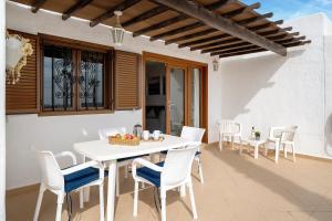 a white table and chairs on a patio at Puerto Chico H in Playa Blanca