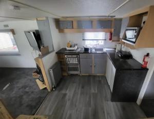 a small kitchen with a sink and a stove at 15 bluebell lane in Hastings