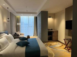 a hotel room with a bed and a television at Sofia International Hotel in Bishkek