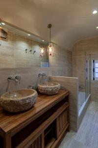 a bathroom with two sinks on a wooden counter at L'Écrin de Luxe by Les Maisons de Charloc Homes in Branville