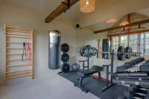 a gym with a bunch of equipment in a room at L'Écrin de Luxe by Les Maisons de Charloc Homes in Branville