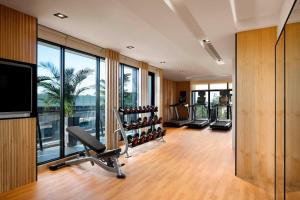 a gym with cardio equipment and a large window at Fairfield by Marriott Taichung in Taichung