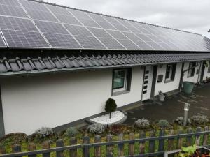 a house with solar panels on the roof at Ferienwohnung Blumenparadies in Nettersheim
