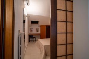a small room with a bed and a table at Miramare apartments in Punta Ala