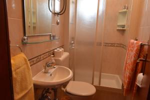 a bathroom with a toilet and a sink and a shower at Villa DELFINA 2 in Podgora