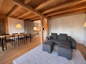 a living room with a couch and a table at Chalet Roossi 4 in Wengen