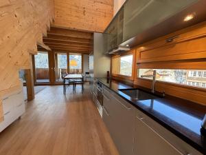 a kitchen with a sink and a counter top at Chalet Roossi 4 in Wengen