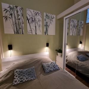 a bedroom with a bed and two paintings on the wall at Rietmeer vakantiehuis Friesland in Gaastmeer