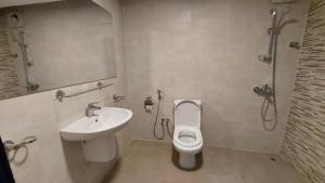 a bathroom with a sink and a toilet and a shower at Grand Flora Salalah in Salalah +19 photos