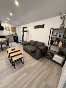 a living room with a couch and a table at Chez FanF & Nanie in Isigny-sur-Mer