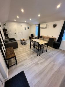 een woonkamer met een tafel en een bank bij Chez FanF & Nanie in Isigny-sur-Mer
