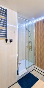 una ducha con puerta de cristal en un baño en Domy Na Wodzie La Mare Houseboats Bydgoszcz, en Bydgoszcz 78 fotos más
