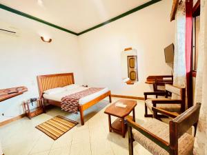 a room with a bed and a chair in it at LE NOUVEL EDEN in Toliara