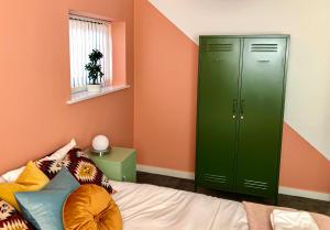 a green cabinet in a room with a bed at Bridge Square Apartments in Lancaster