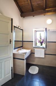 a bathroom with a sink and a mirror and a window at Agriturismo Tenuta San Michele in Santa Venerina