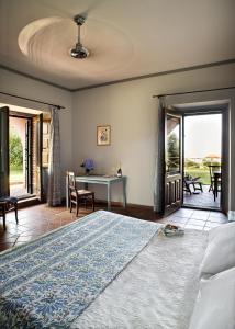 a bedroom with a bed and a table and chairs at Agriturismo Tenuta San Michele in Santa Venerina