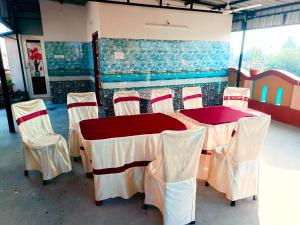 a room with a table and chairs in it at Rabindra Bilas Homestay in Bolpur