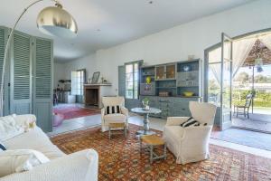 a living room with a couch and chairs and a table at Sa Palmera in Montuiri