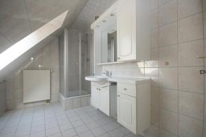 a white bathroom with a sink and a staircase at Ferienwohnungen Fründt in Prerow +39 photos