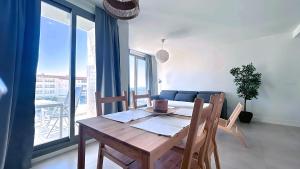a wooden table and chairs in a room with a window at Panorama Beach - Sea Breeze Apartment in Torrox Costa