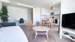 a room with a bed and a table and a kitchen at Panorama Beach - Sea Breeze Apartment in Torrox Costa