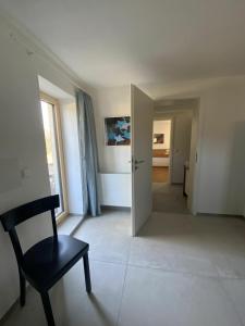 an empty room with a chair and a door at Gruppenhaus Baiersbronn LUG INS TAL in Baiersbronn