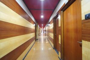 a corridor of a hallway with wooden walls and doors at FabHotel Rahul Palace in Nagpur