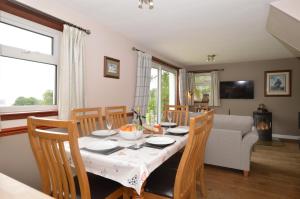 a dining room with a table and chairs at Larch Cottage in Blairmore