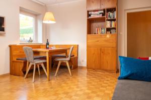 a living room with a dining room table and chairs at Apartment Bellevue Seis in Siusi