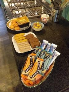 a counter with cookies and crackers and snacks on it at BoHo Experience Wellness, Jacuzzi, Sauna, BBQ, Garden, Sleeps 10 in Kockengen