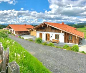 a house with an orange roof on a road at Bergchalet 3 in Freyung