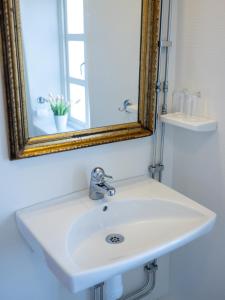 a white sink in a bathroom with a mirror at Anita på Gästis i Anderslöv in Anderslöv