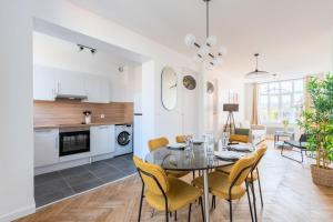 a dining room and living room with a table and chairs at Charming through-apartment renovated and equipped! in Marcq-en-Baroeul +19 photos
