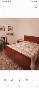 a bedroom with a bed and a chair at Al casale in Capriglia