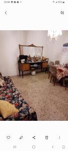 a living room with two beds and a mirror at Al casale in Capriglia