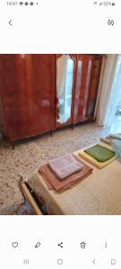 a room with a bed and a cabinet with towels at Al casale in Capriglia