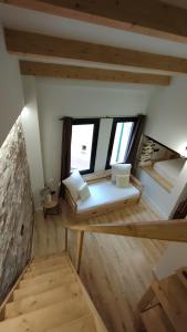 an attic room with a bed and two windows at Cal Rei in Grañena de Cervera