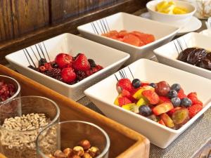 a table topped with white bowls filled with fruits and vegetables at Hill Crest Country Guest House in Newby Bridge