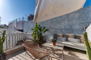 balcone con divano, tavolo e sedie di Casa Azul by Hello Homes Sitges a Sitges