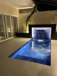 a swimming pool with a fountain in a house at بيت عطلات مفروش بالخبر in Al Khobar