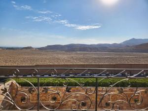 a view of the desert from a balcony with a bench at Royal Mountain in Luxor
