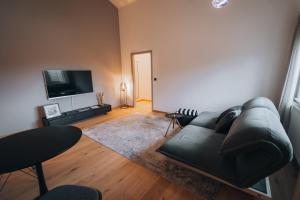 a living room with a couch and a flat screen tv at Gut Buchenhof in Buchenberg