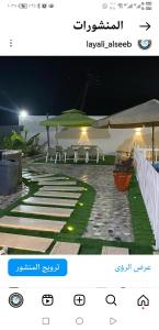 a screenshot of a website of a patio at night at شاليه ليالي السيب in Seeb