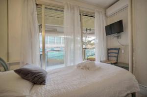 a bedroom with a bed and a window with a pool at One Bed Apt in the center of Cannes - 2198 in Cannes