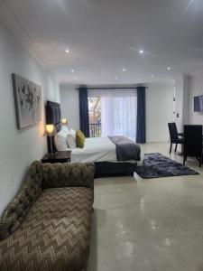 a large hotel room with a bed and a couch at Le Bamboo Guest House And Boat Cruise in Hartbeespoort