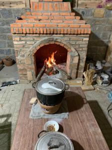 a brick oven with a pot in front of it at Chú Ba Farmstay - cách Đà Lạt 40km in Ấp Phú Thuận +36 photos
