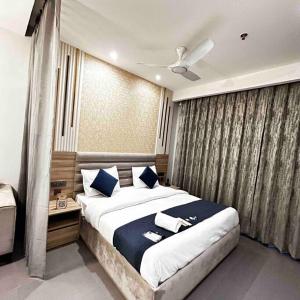 um quarto com uma cama grande e almofadas azuis em Tranquil river heaven ! em Noida