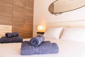 a bedroom with a bed with towels on it at Gtrip P Faliro Coastal Comfort 3F in Athens