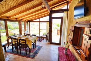 a dining room with a table and chairs in a house at Kilim Kaya Villas in Kınalı